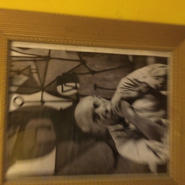 A Framed photograph of Pablo Picasso in his studio sat opposite his painting of La Cuisine in 1948