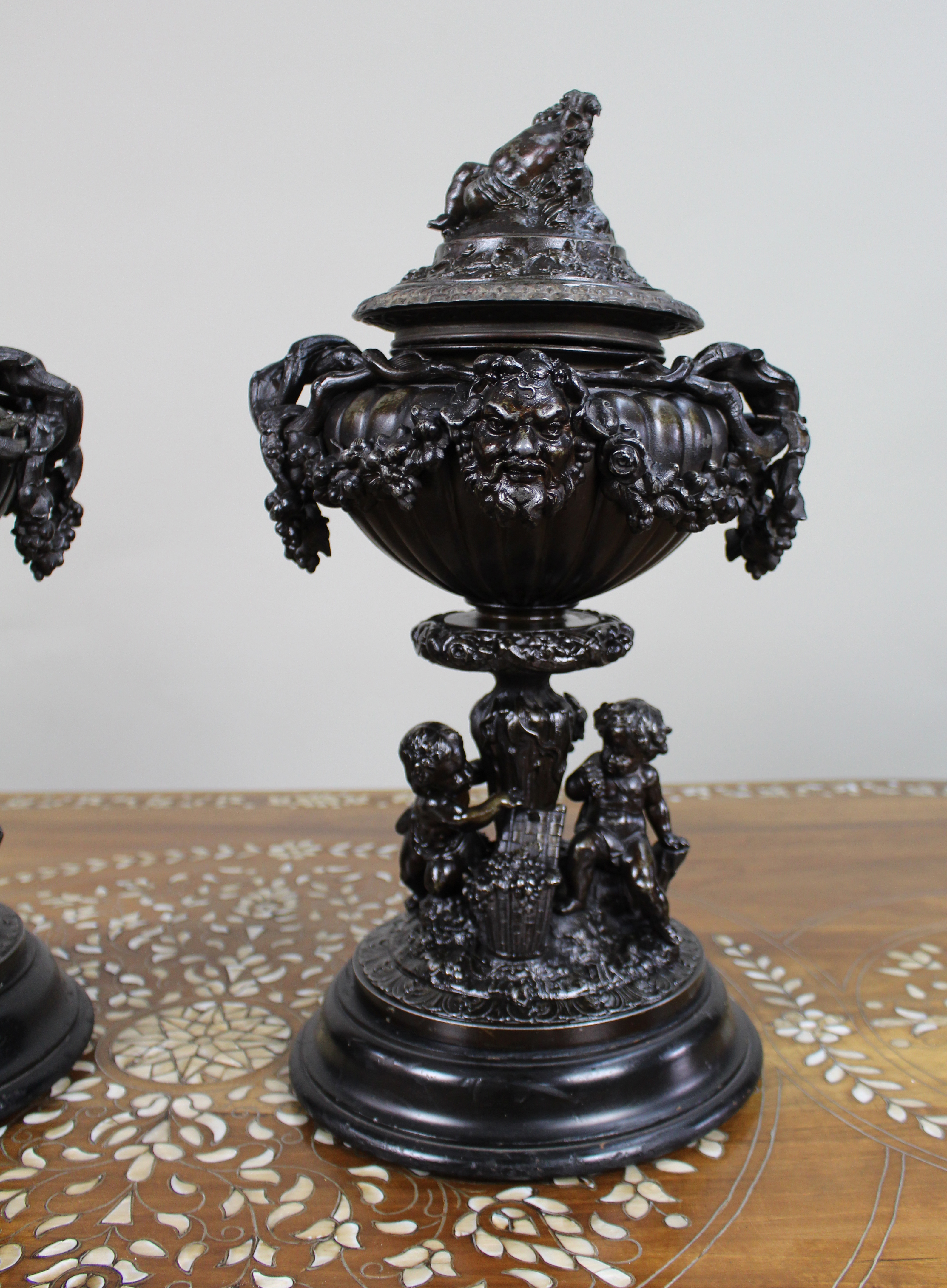 Pair of French Bronzed Spelter Urns with Bacchic Masks and Putti, Circa 1880