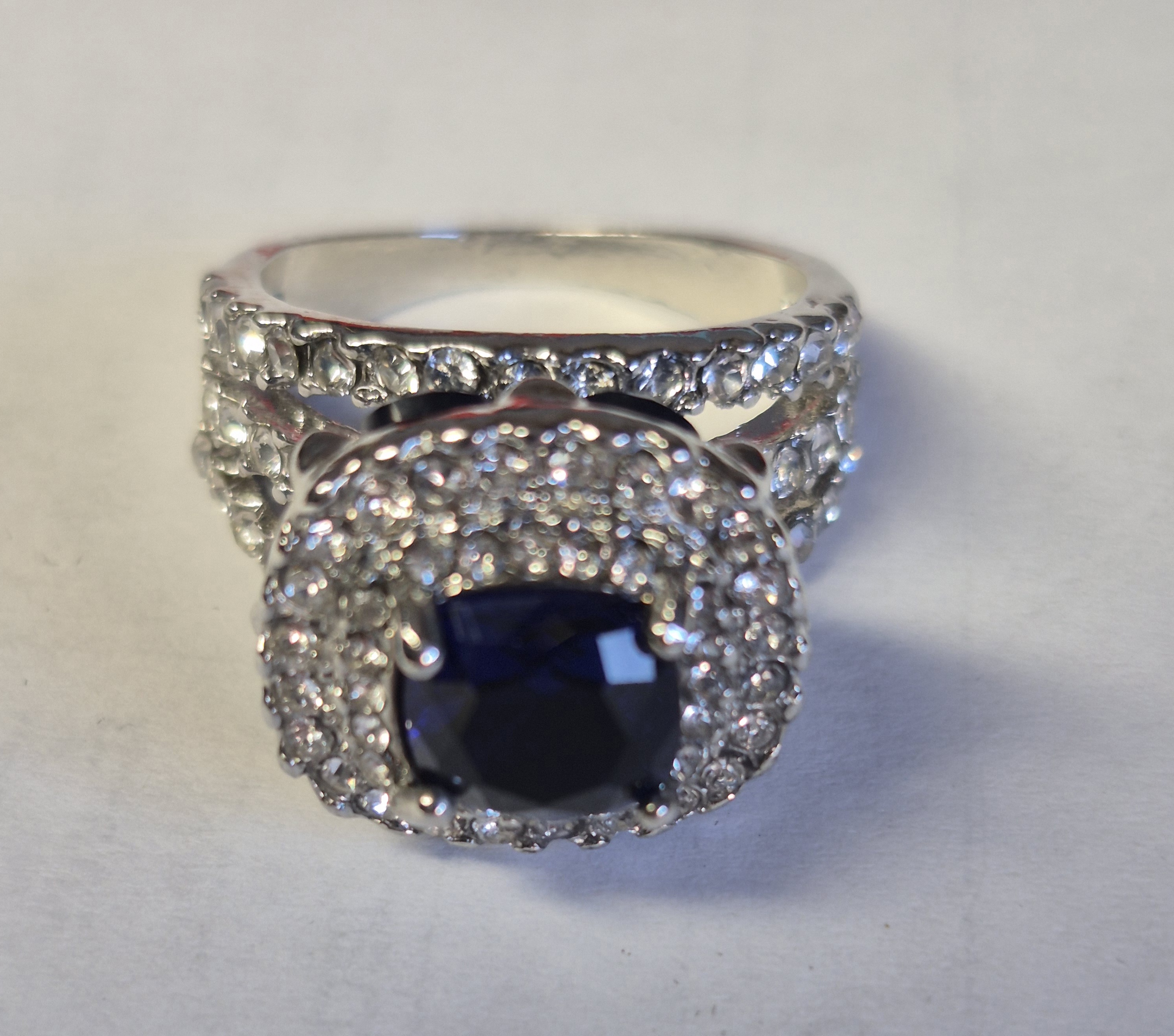 Silver-Plated Ring With Deep Blue Cushion-Cut Stone & Halo Accent Design