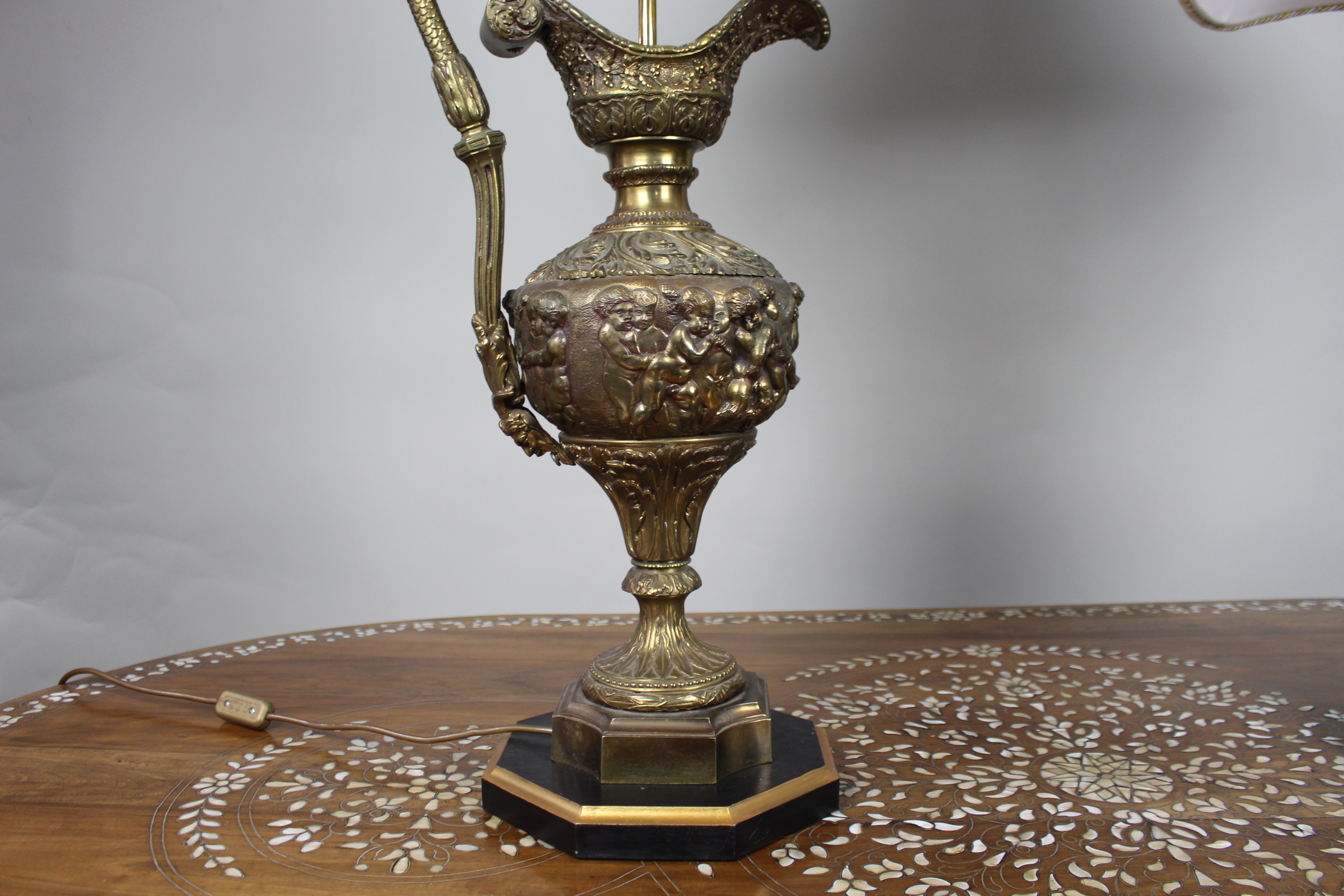 Pair of Early 20th Century French Neoclassical Ewer Lamps with Putti Relief