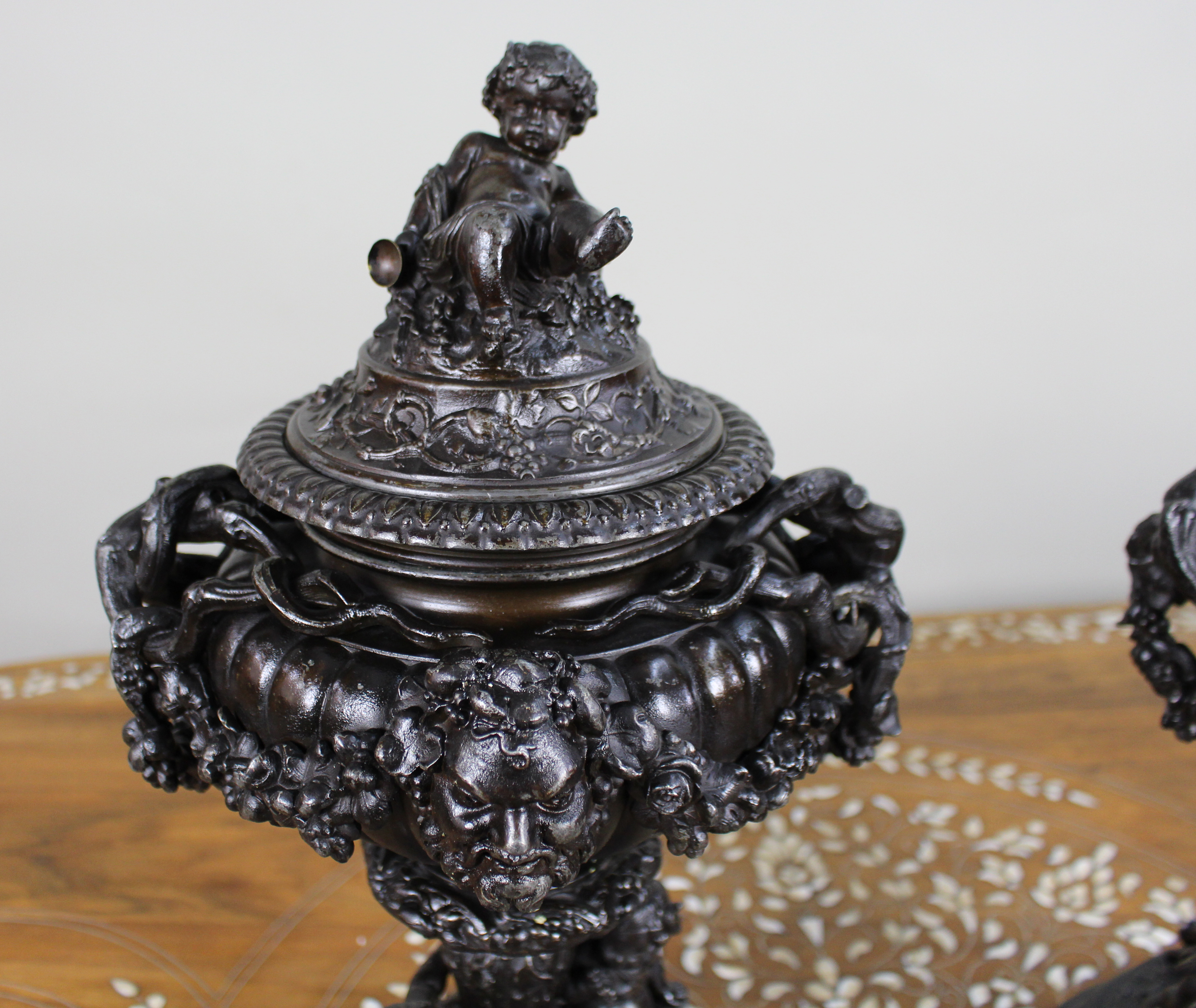 Pair of French Bronzed Spelter Urns with Bacchic Masks and Putti, Circa 1880