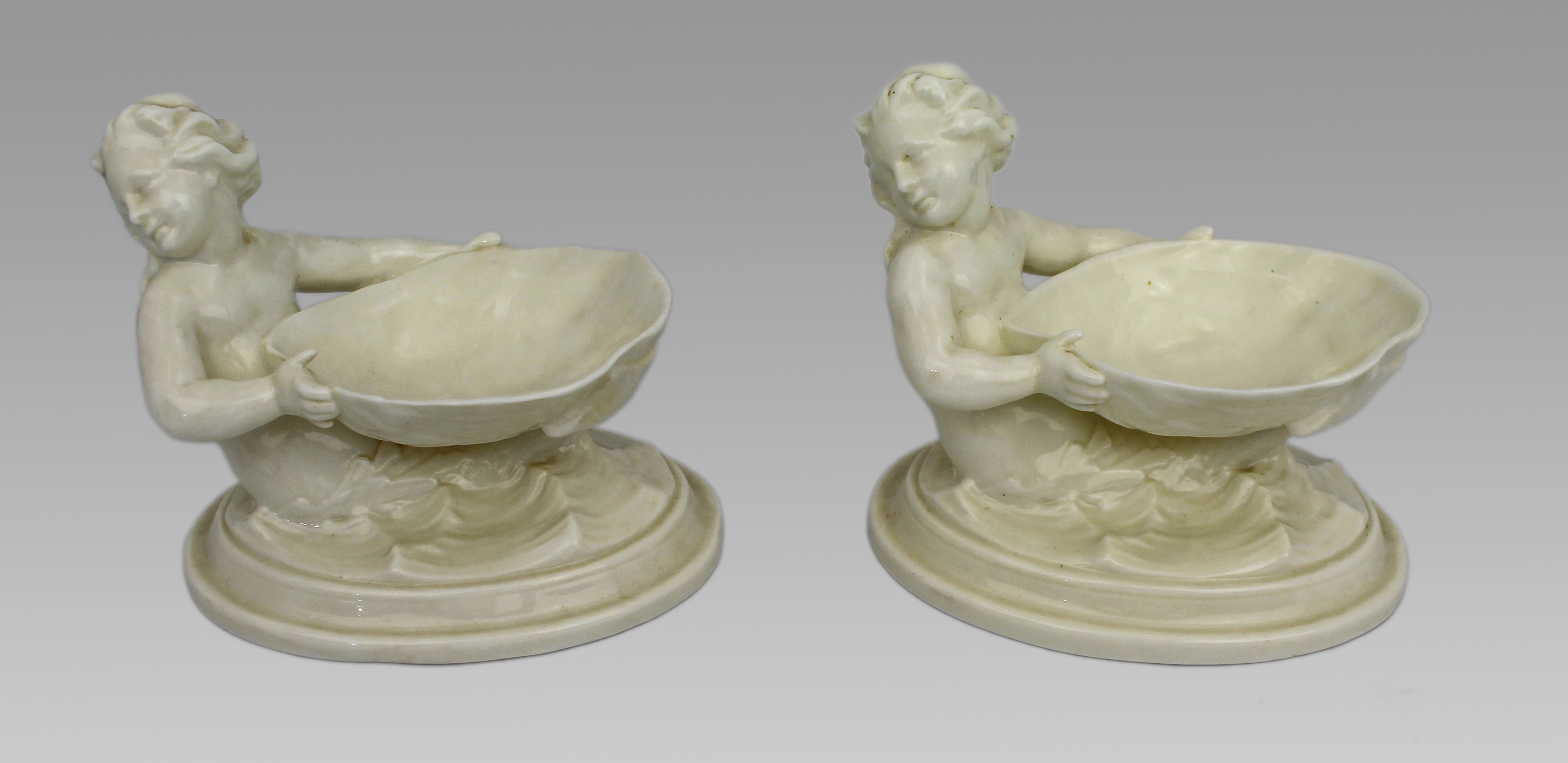 Pair of Royal Worcester Blanc de Chine Merchild Salt Cellars