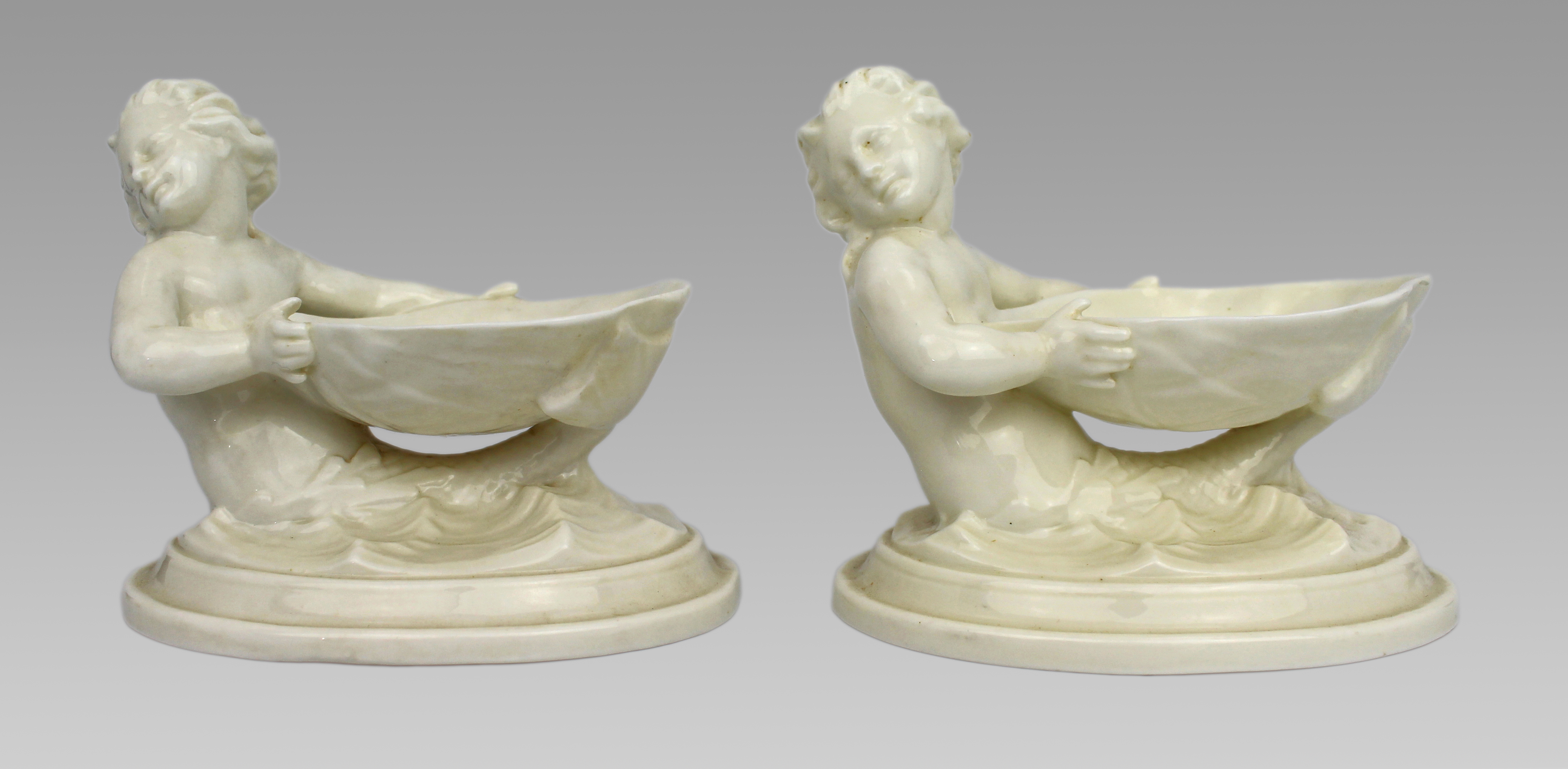 Pair of Royal Worcester Blanc de Chine Merchild Salt Cellars