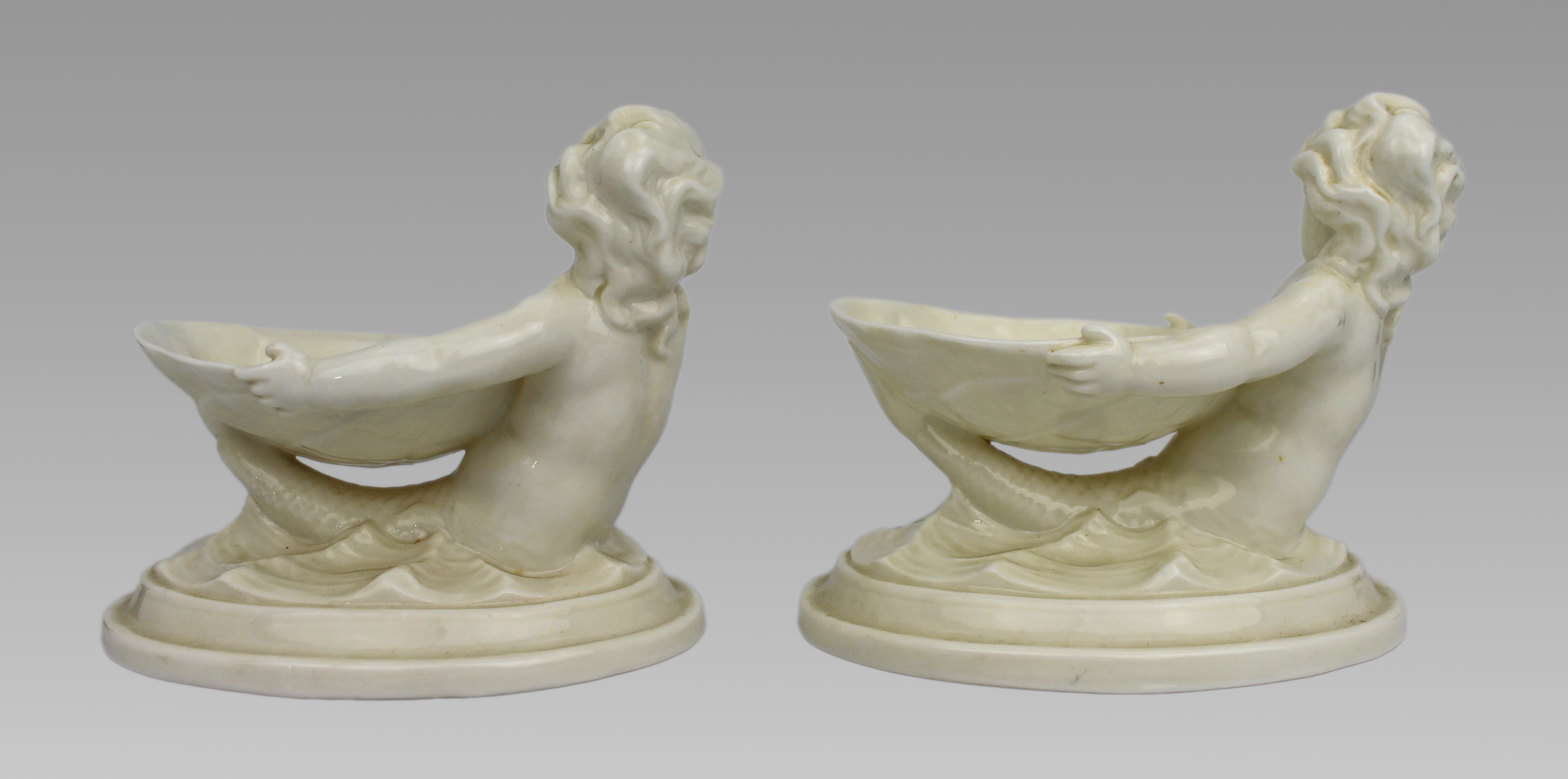 Pair of Royal Worcester Blanc de Chine Merchild Salt Cellars
