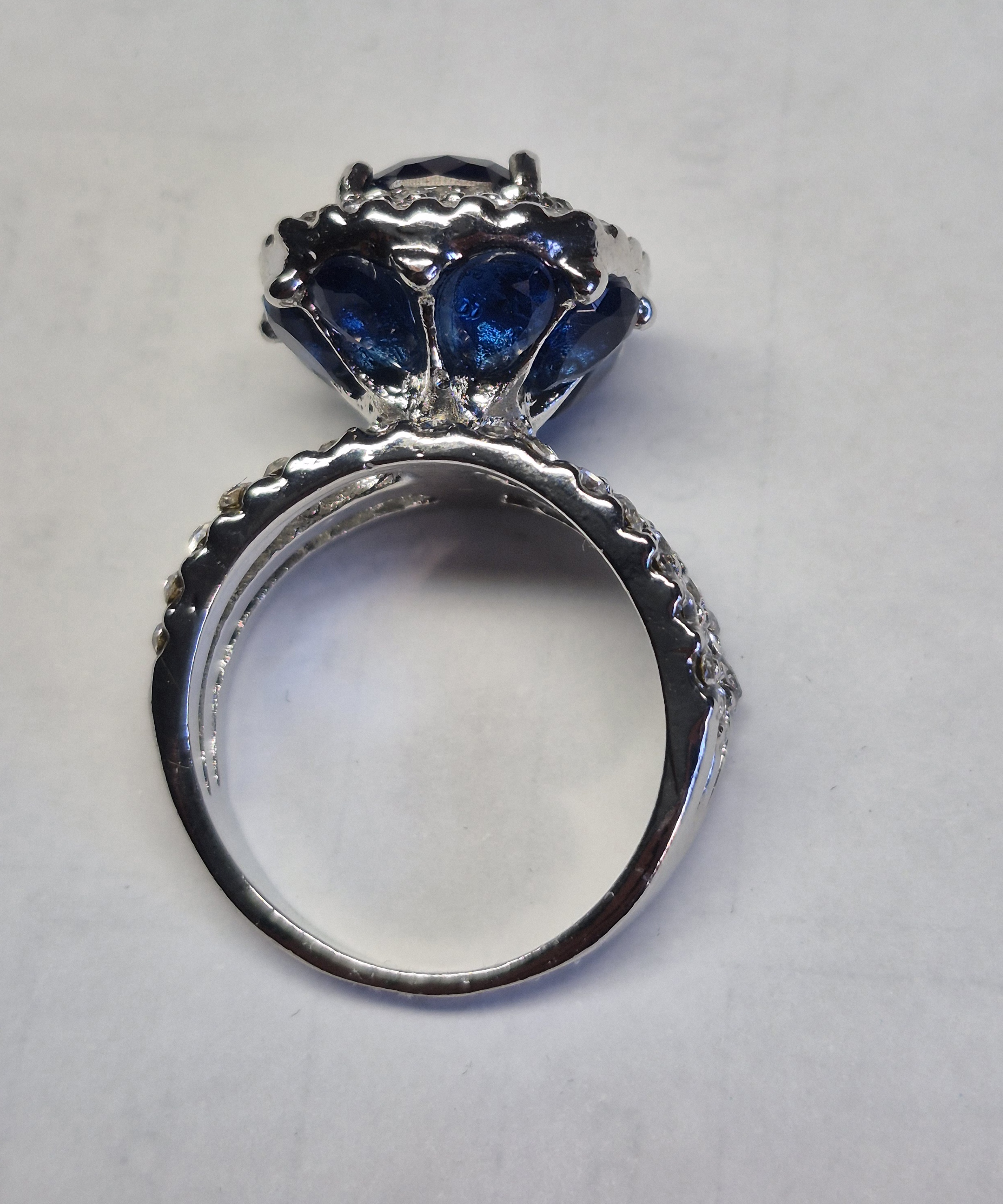 Silver-Plated Ring With Deep Blue Cushion-Cut Stone & Halo Accent Design