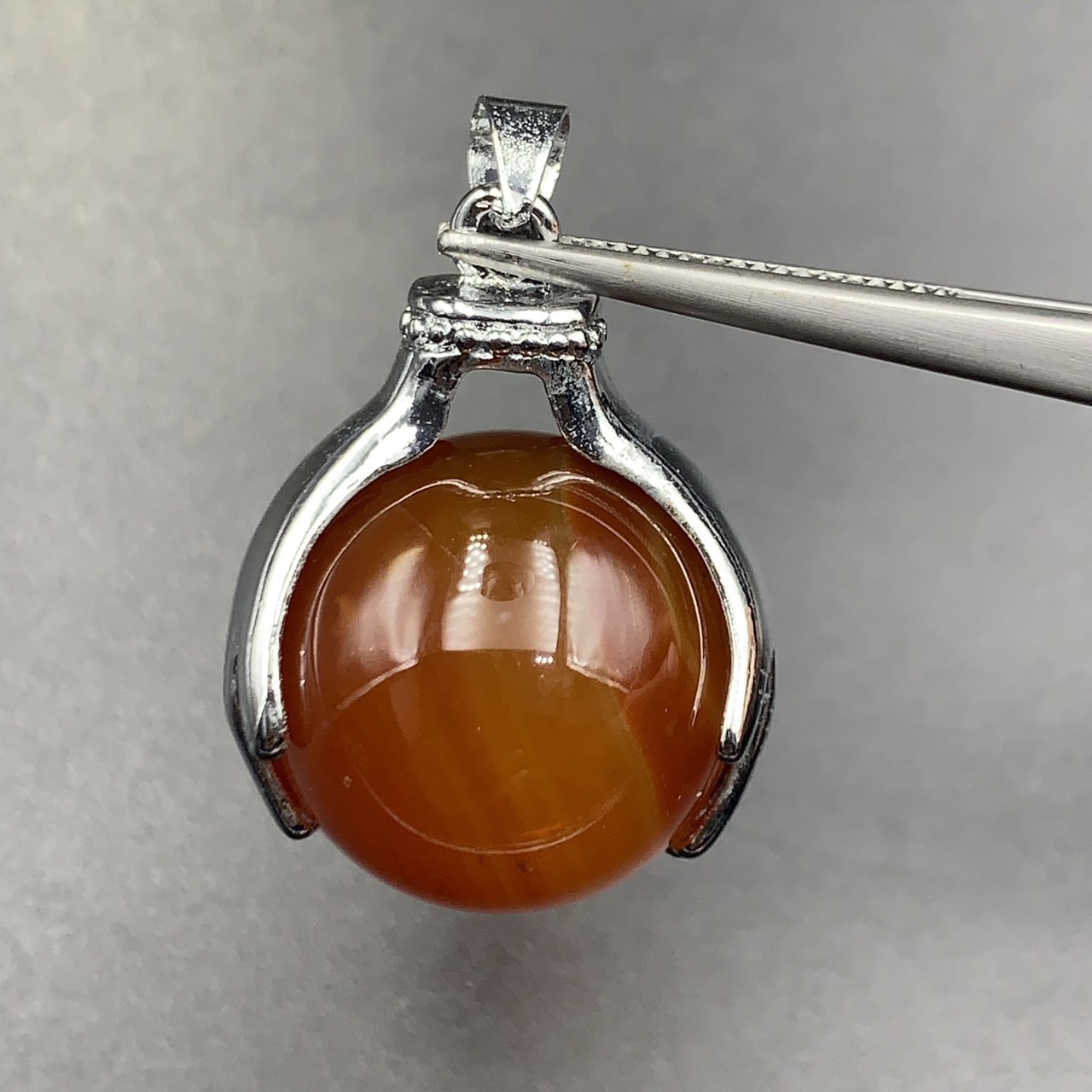 74.45Cts Awesome Natural Carnelian Sphere Agate With Holding Hands Stainless Steel Pendant. BCM-5