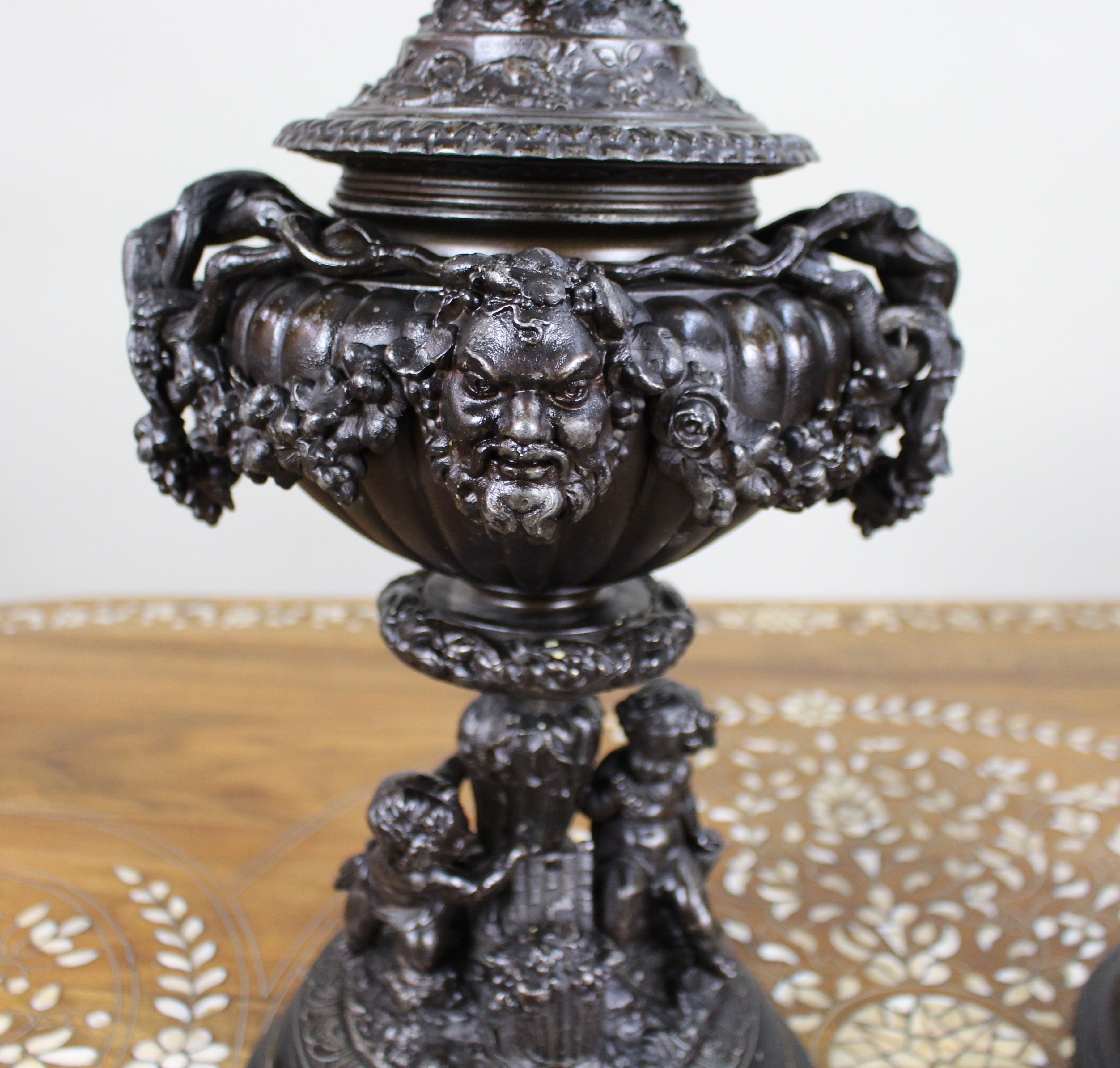 Pair of French Bronzed Spelter Urns with Bacchic Masks and Putti, Circa 1880