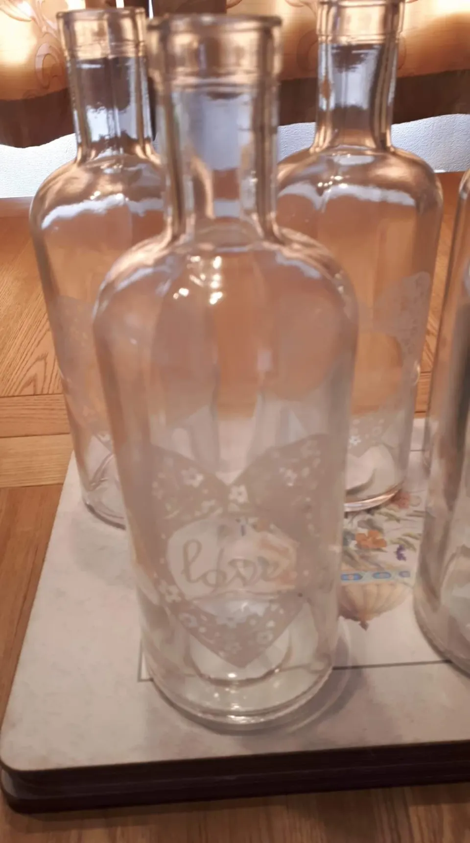 4 boxes of decorative bottle vases with "Love" written on them.  6 bottles in each box