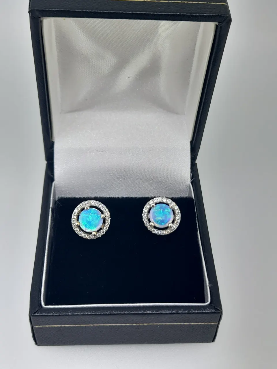 Silver and Synthetic Opal Stud Earring With CZ Halo