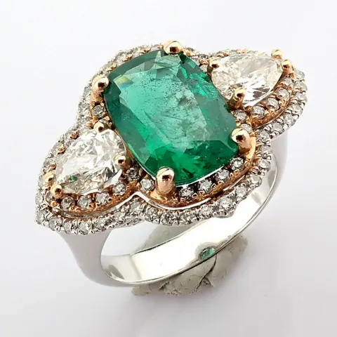 An exquisite ring detailed with vibrand emerald, different cut diamonds