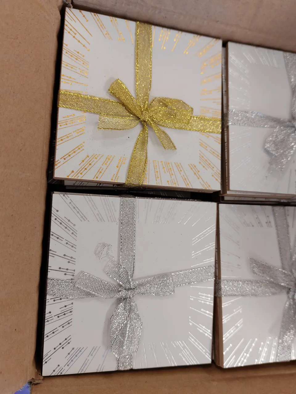 Box of 96 white coasters with gold and silver patterns