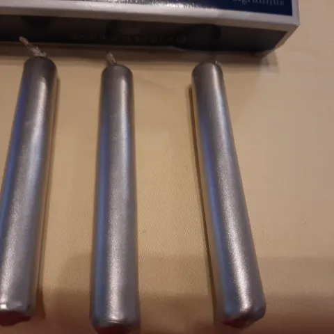 4 x packs small silver candles plus pack of longer candles
