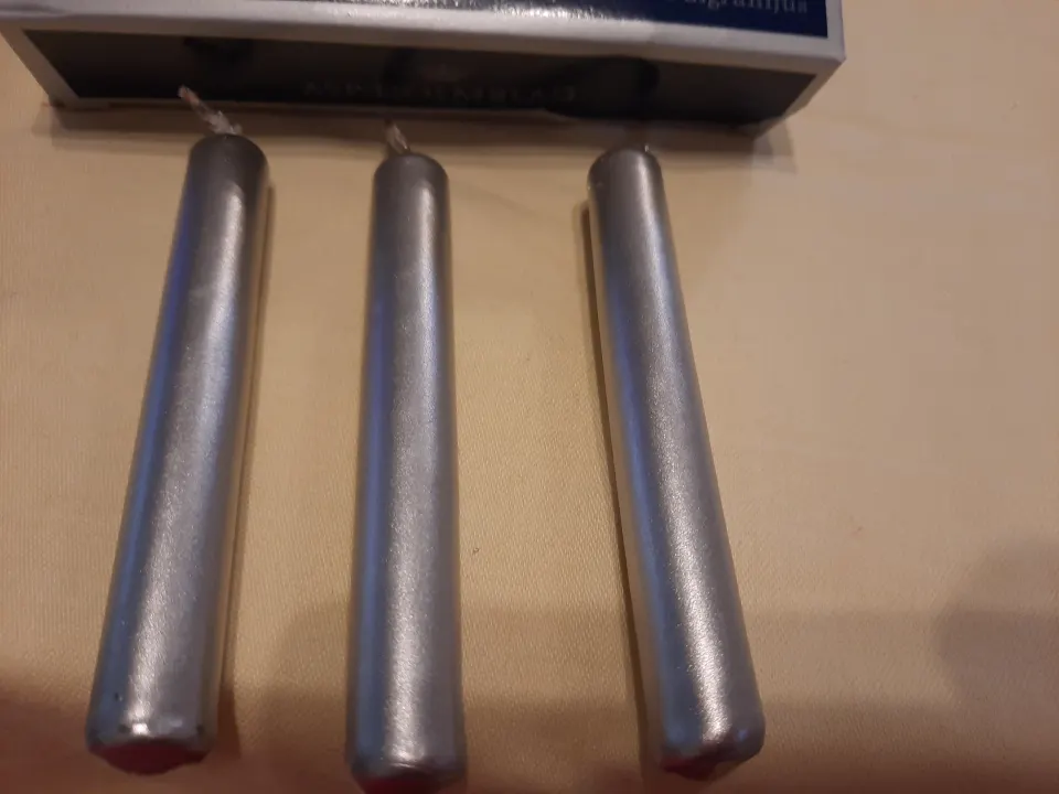 4 x packs small silver candles plus pack of longer candles