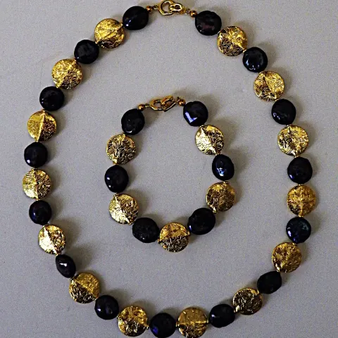 A Necklace and Bracelet Set With Rare, Natural, Black, Round Flat Pearls