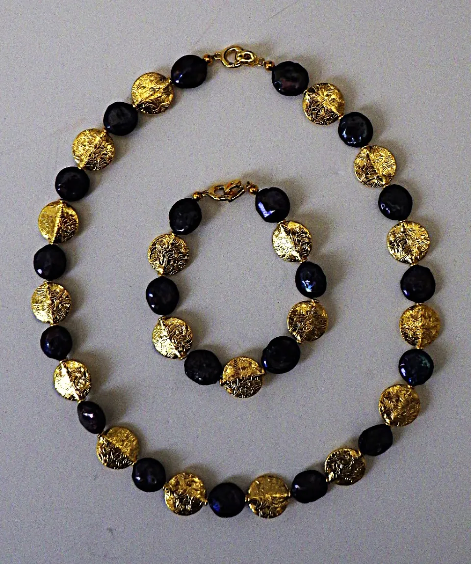A Necklace and Bracelet Set With Rare, Natural, Black, Round Flat Pearls