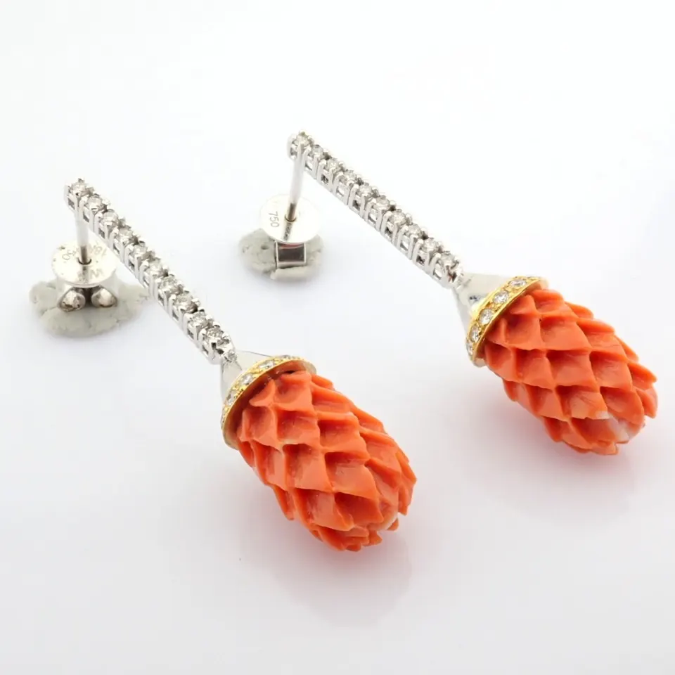 An exquisite earrings  detailed with carved-coral, brilliant diamonds and gold