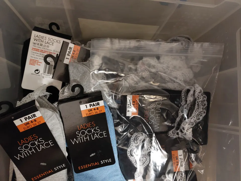 Box of 24 pairs of socks, blue, grey and black with lace edging