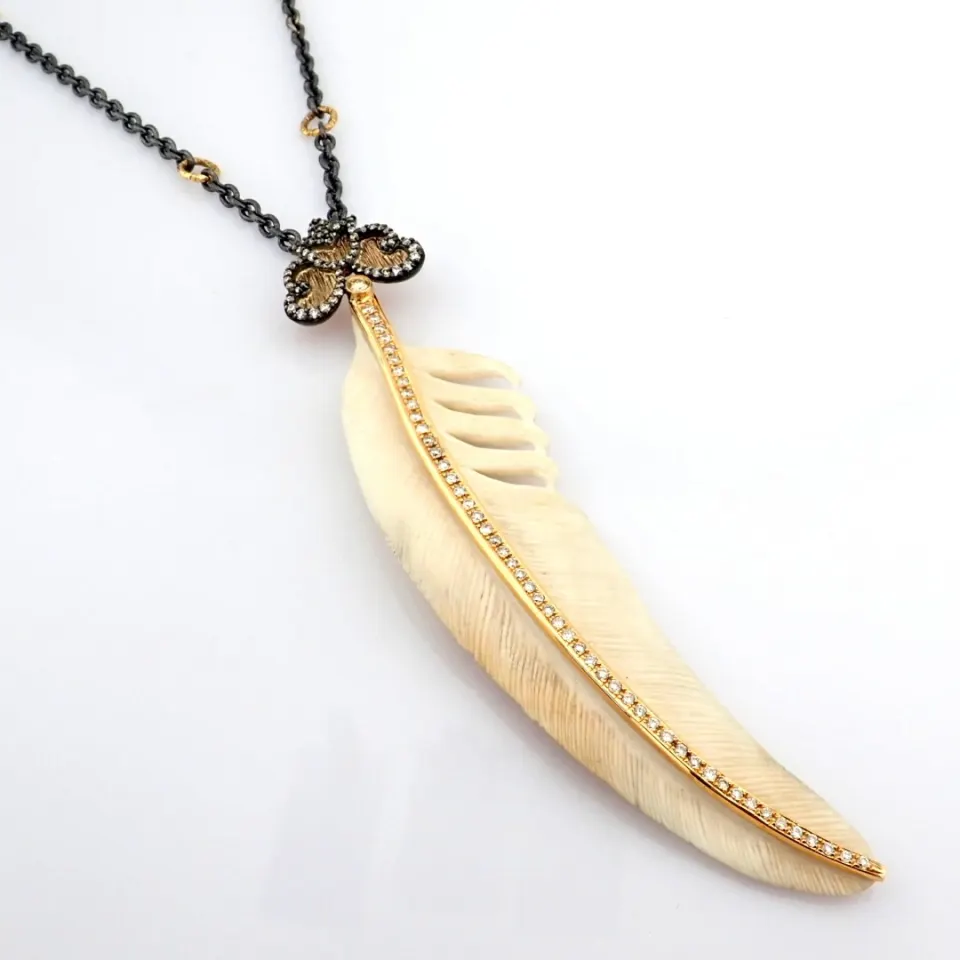 An Exquisite Bone-Carved Feather Necklace Detailed With Brilliant Diamonds and Gold On Silver