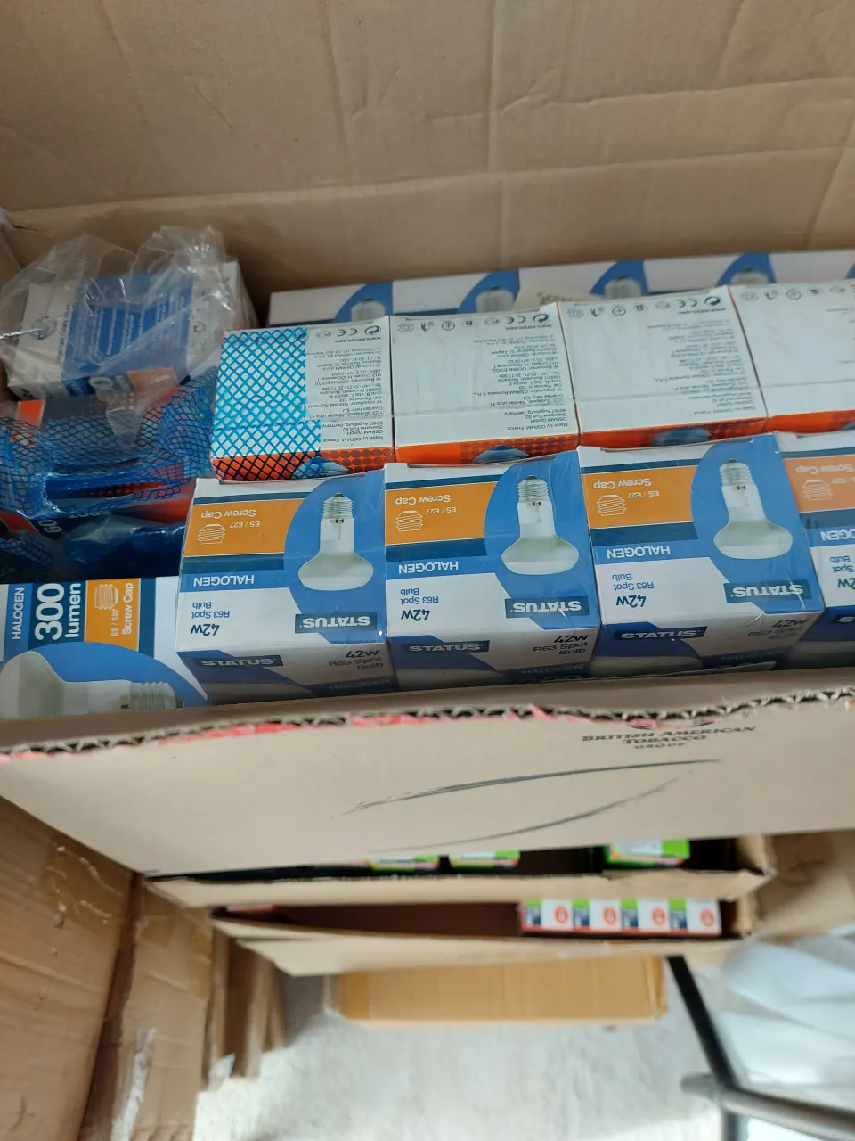 Box of mixed goods.  Lightbulbs, combs, boom targets, stationery items plus more
