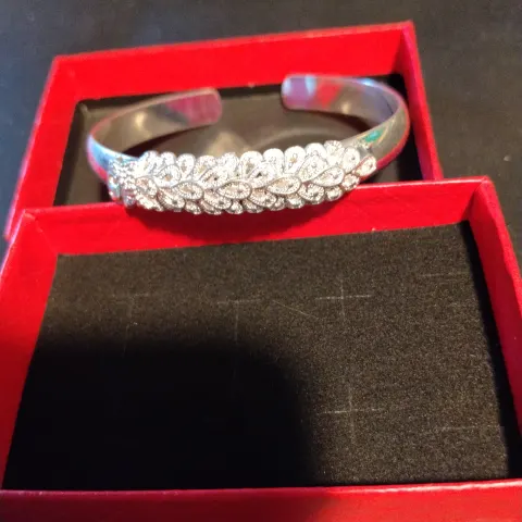 Open Cuff Bangle In Bright White Metal With A Solid Plain Band and A Central Applied Panel of Openwo