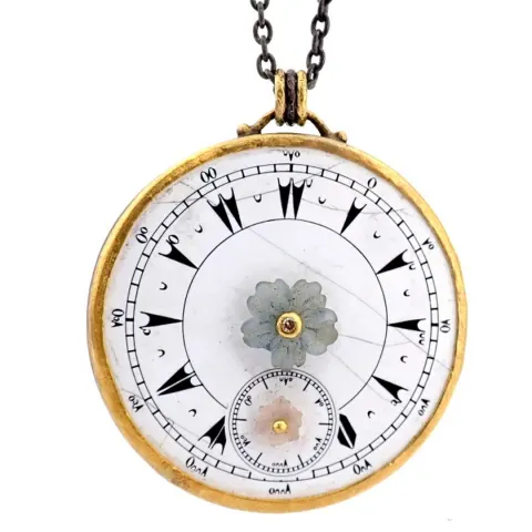 An exquisite necklace made of gold and silver, featuring an antique watch dial adorned with diamonds