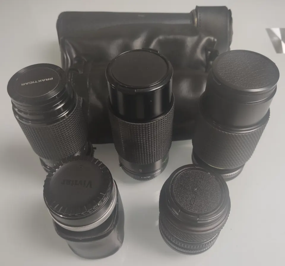A collection of 5 x camera lenses. Tokina – Pentacon – MNK – Vivitar.