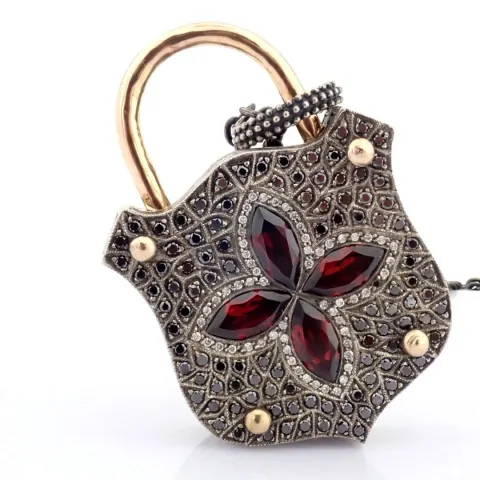An exquisite clasp necklace embellished with gold, colorful stones and diamonds on silver