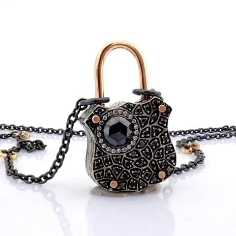 An exquisite, convertible clasp necklace embellished with gold and diamonds on silver