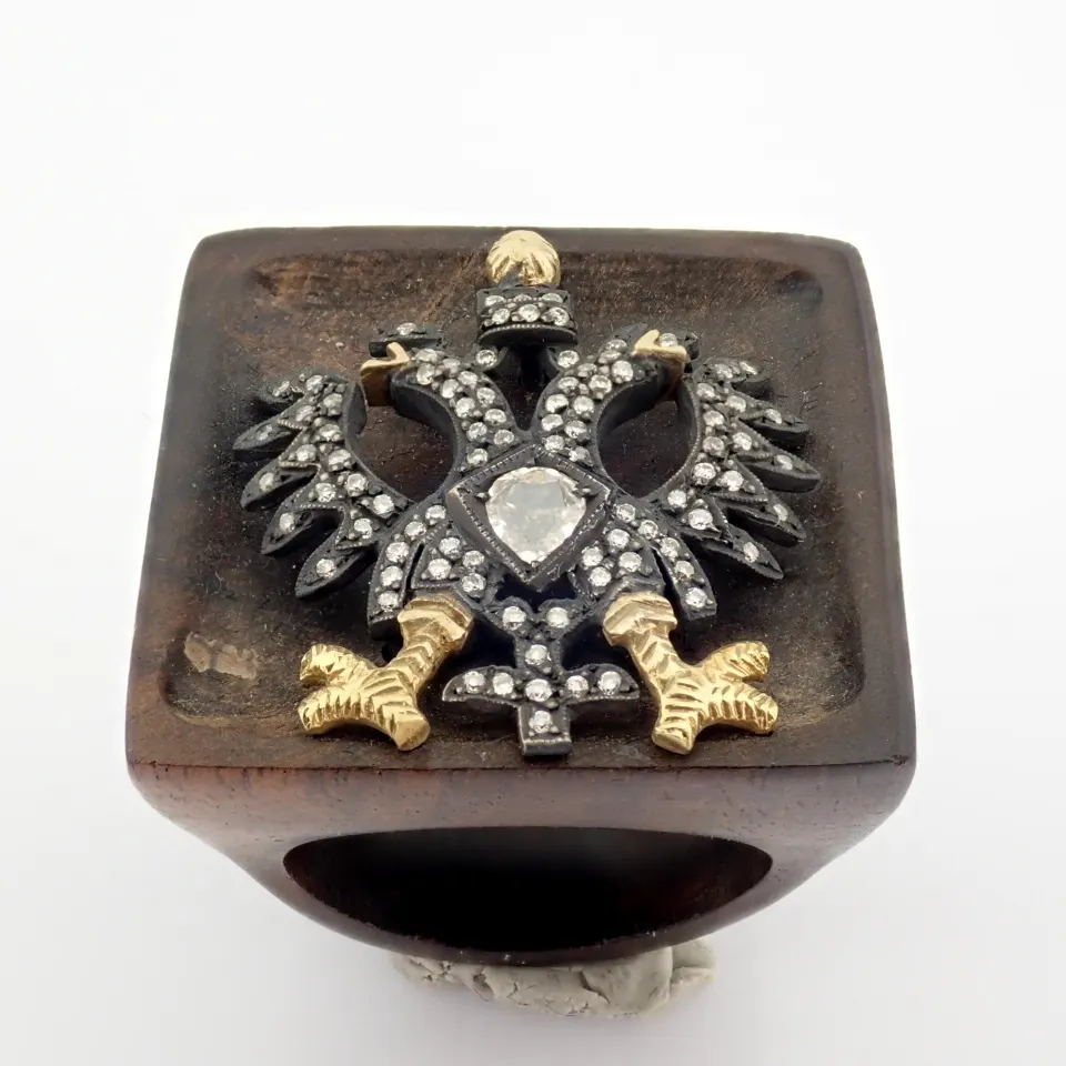 An Exquisite Eagle Ebony Ring Detailed With Brilliant Diamonds and Gold On Silver.