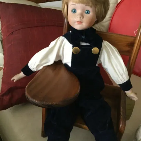 Andrew Schofield Victorian Doll sitting on a very cute wooden chair