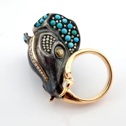 An exquisite elephant ring detailed with turqouise. brilliant diamonds and gold on silver.