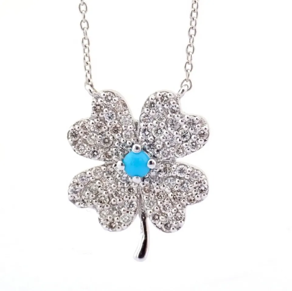An exquisite 18k white gold clover necklace  detailed with turquoise and brilliant diamonds