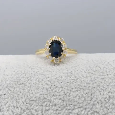 Oval-cut Sapphire and Round Brilliant-cut Diamond Cluster Ring In 18ct Yellow Gold