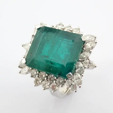 18K white gold cluster ring detailed with vibrand emerald and pear cut and brilliant diamonds
