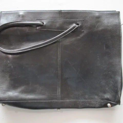Ladies black leather tote as pictured has some marks , previous use -