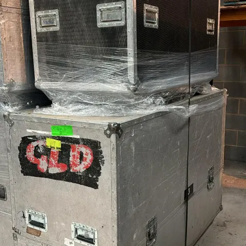 2x Flight Cases with 4 Seater Black Modular Sofa and arms