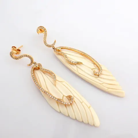 An exquisite bone-carved wing earrings  detailed with brilliant diamonds and gold