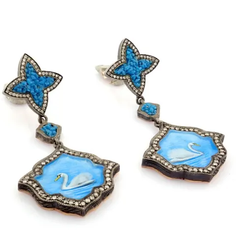 An exquisite earrings made of brilliant diamonds and gold in silver detailed of micro art