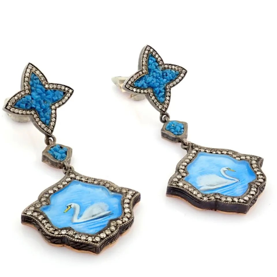 An exquisite earrings made of brilliant diamonds and gold in silver detailed of micro art