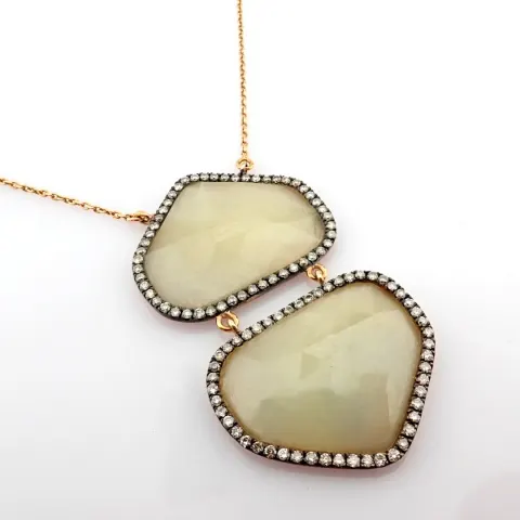 Gold necklace with fancy cut rough Sapphire and brilliant diamonds on silver frame