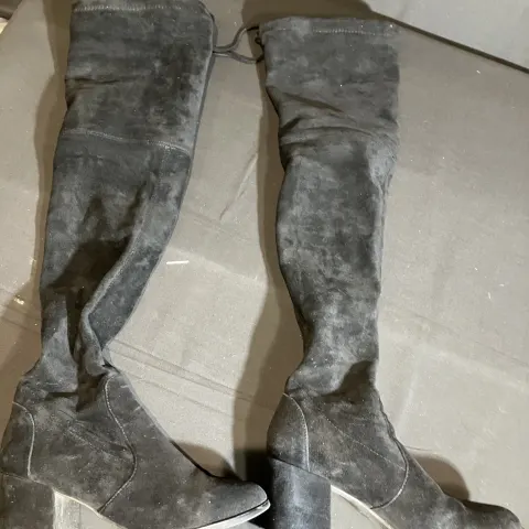 Black boots worn by a body double