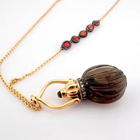 A perfume bottle necklace carved from smoky topaz, adorned with precious stones, gold and silver
