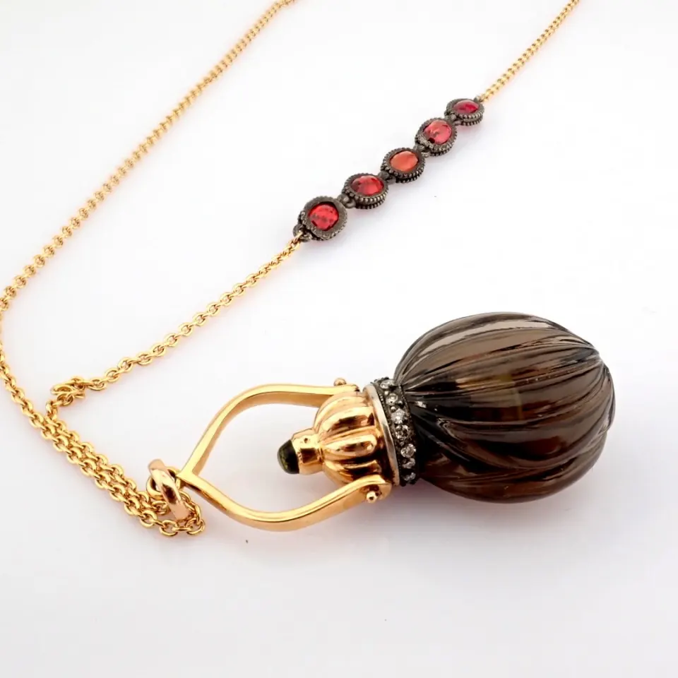 A perfume bottle necklace carved from smoky topaz, adorned with precious stones, gold and silver