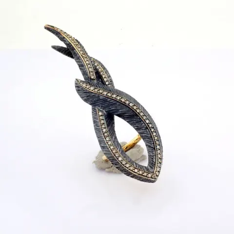 An exquisite feather ring detailed with brilliant diamonds and gold on silver.