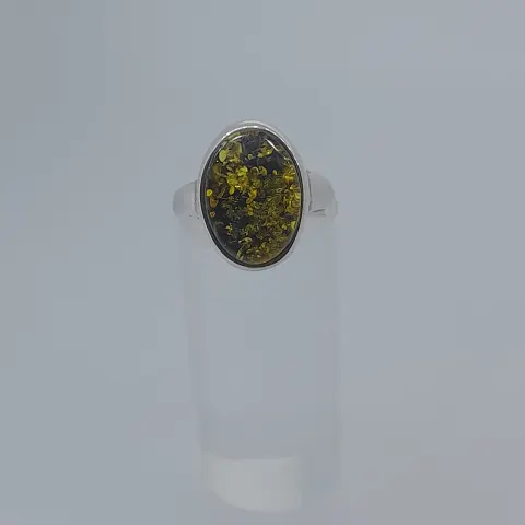 Silver ring set with natural green amber