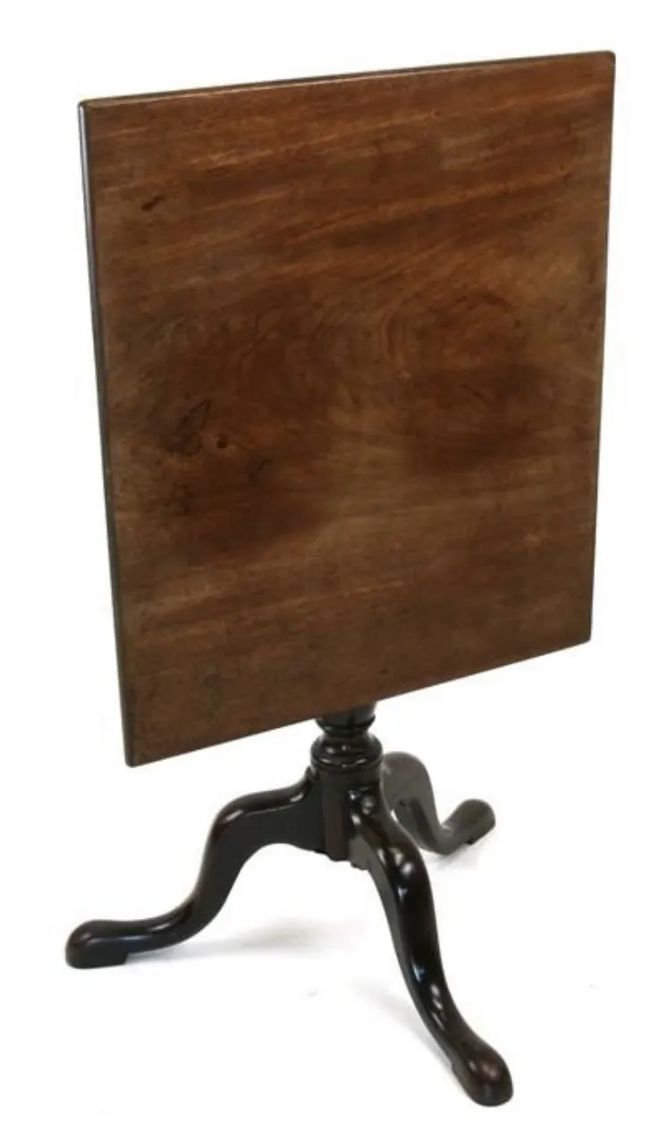 An early 19th century rectangular tilt-top table on turned column and tripod base