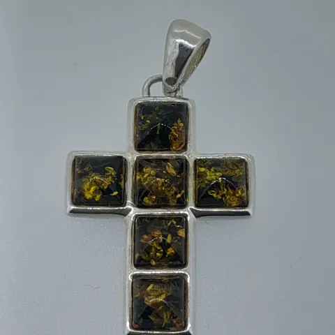 Silver cross set with natural green amber