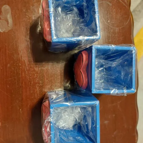 Wooden pots for pencils and knick knacks.  Pink and blue