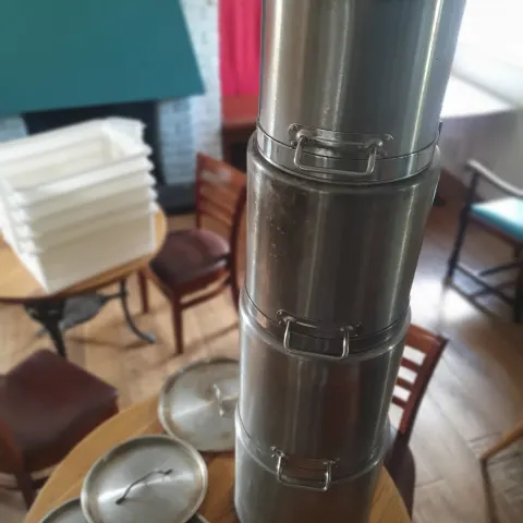 A set of 4 heavy base tall stainless steel pots with lids