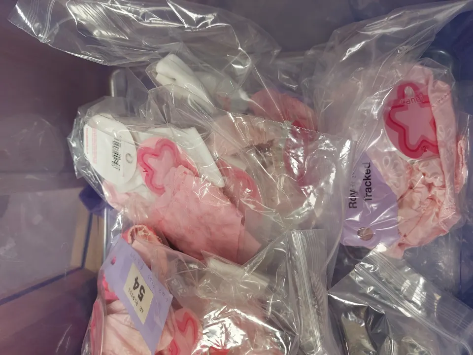 Box of children's pink and white hair accessories